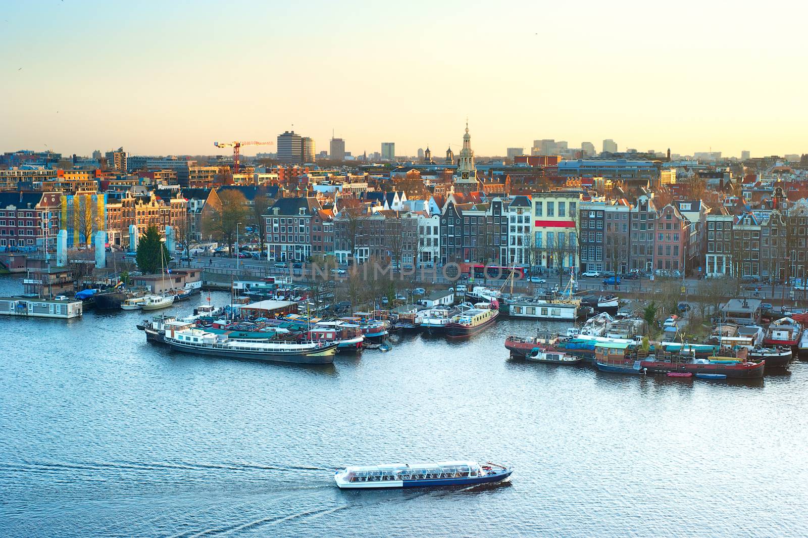 Cityscape of Amsterdam at colorful sunset. Aerial view