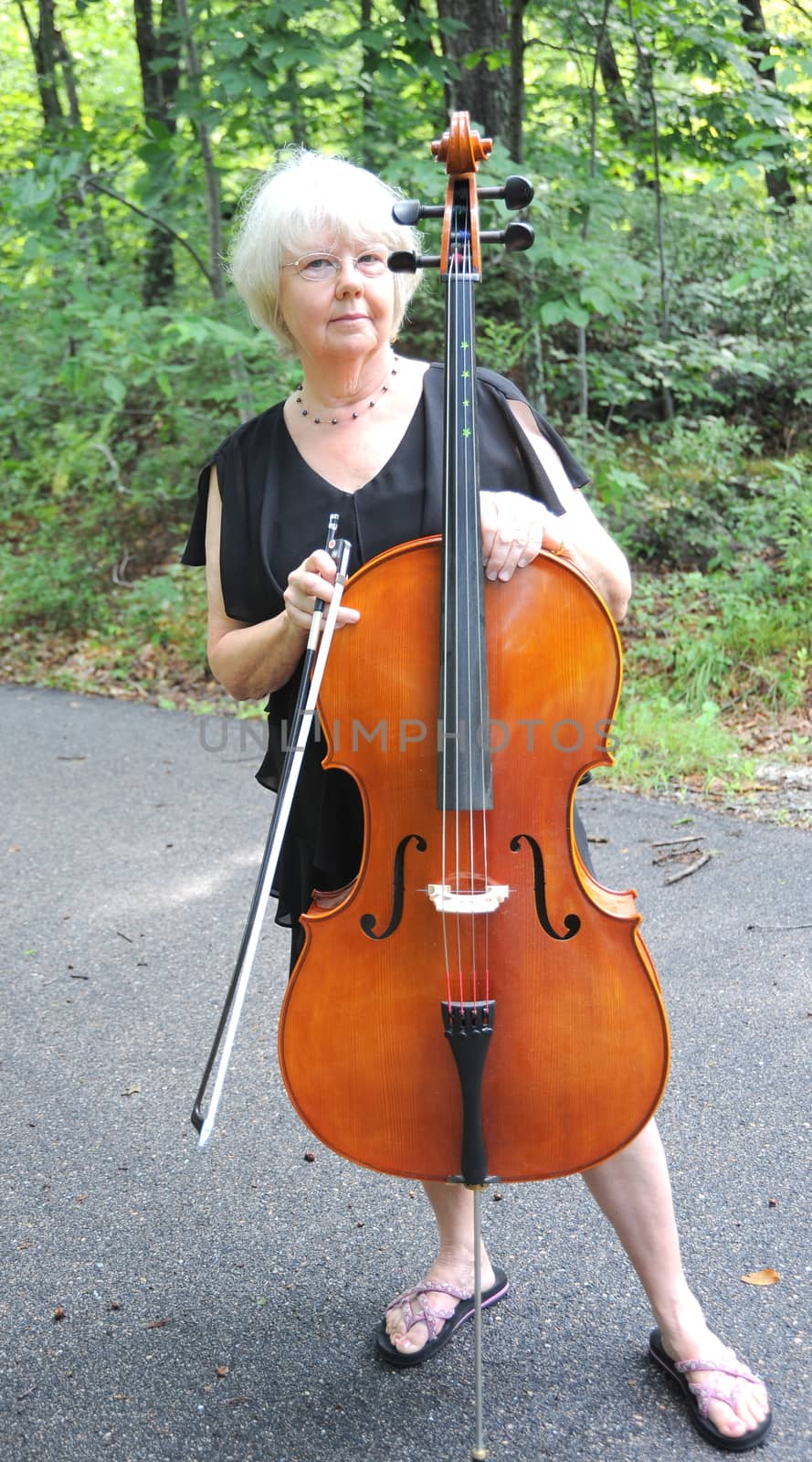 Female cellist performing a classical piece outside.