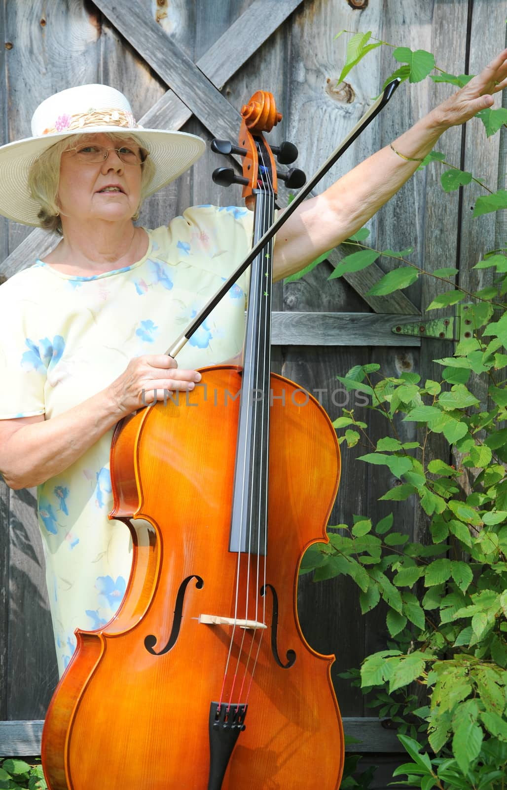 Female cellist performing a classical piece outside.