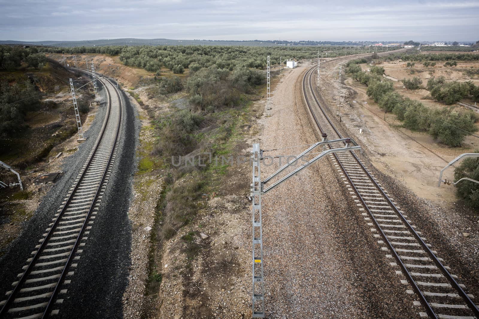 train rails with a city at the background, Jaen, Spain by digicomphoto