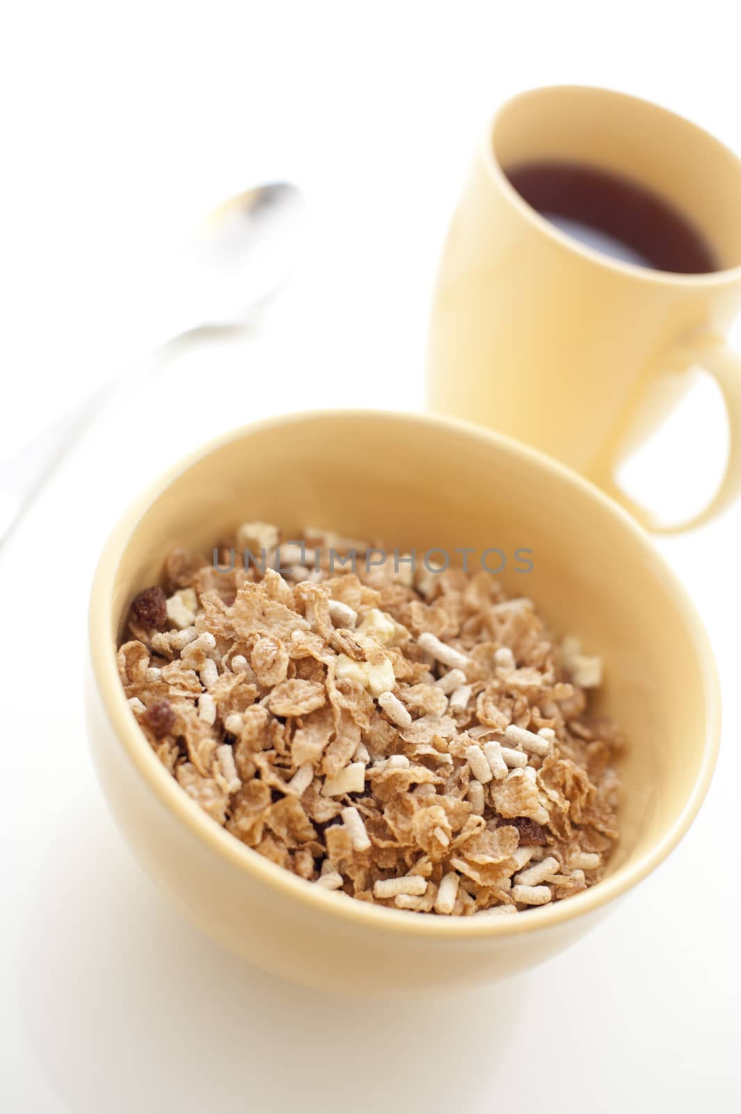 Healthy bowl of muesli breakfast cereal served with mug of aromatic hot espresso coffee for an energising start to the day