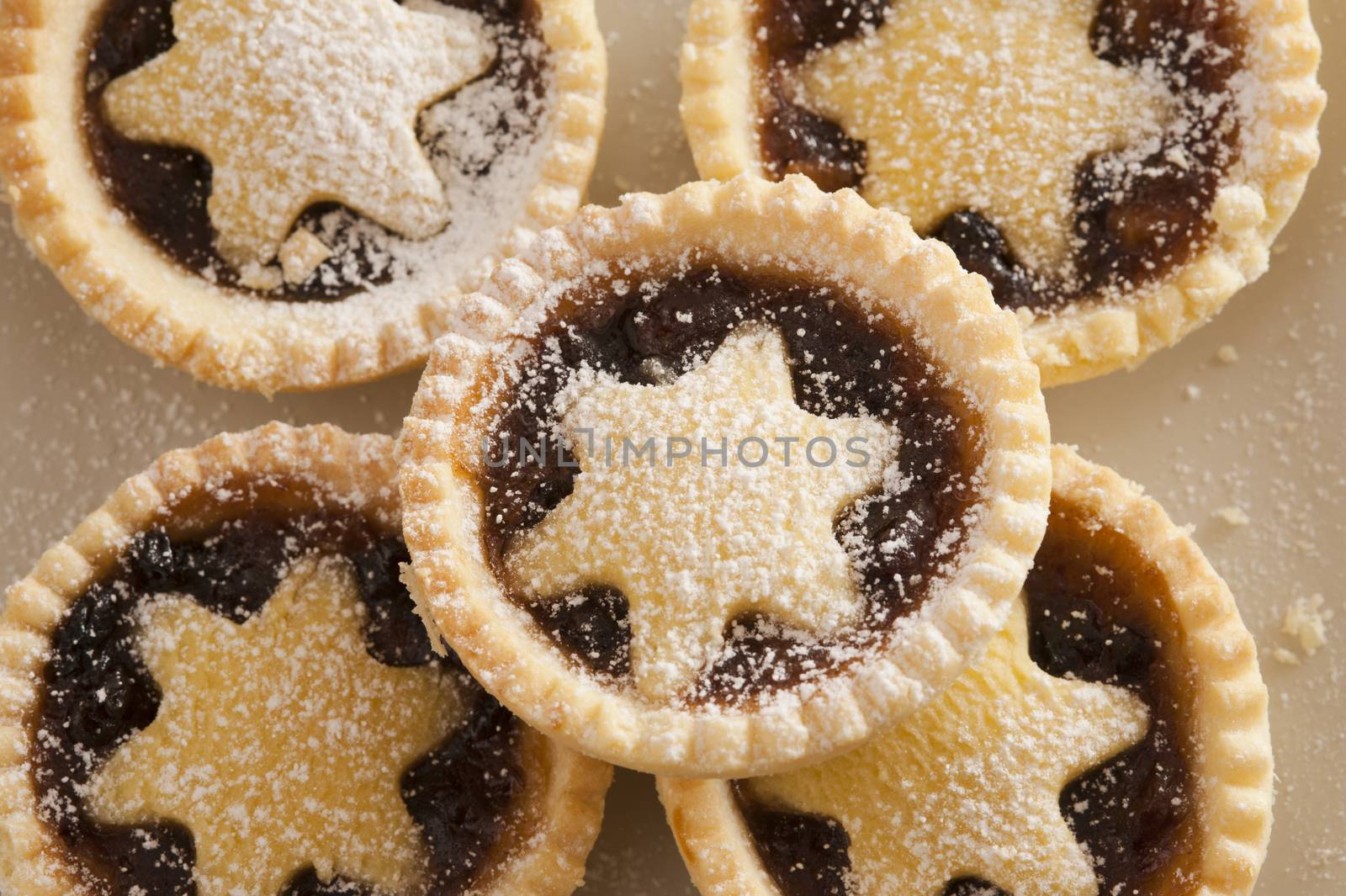 Background texture of decorative Christmas mince pies with crisp golden crusts and pastry stars for a traditional seasonal treat
