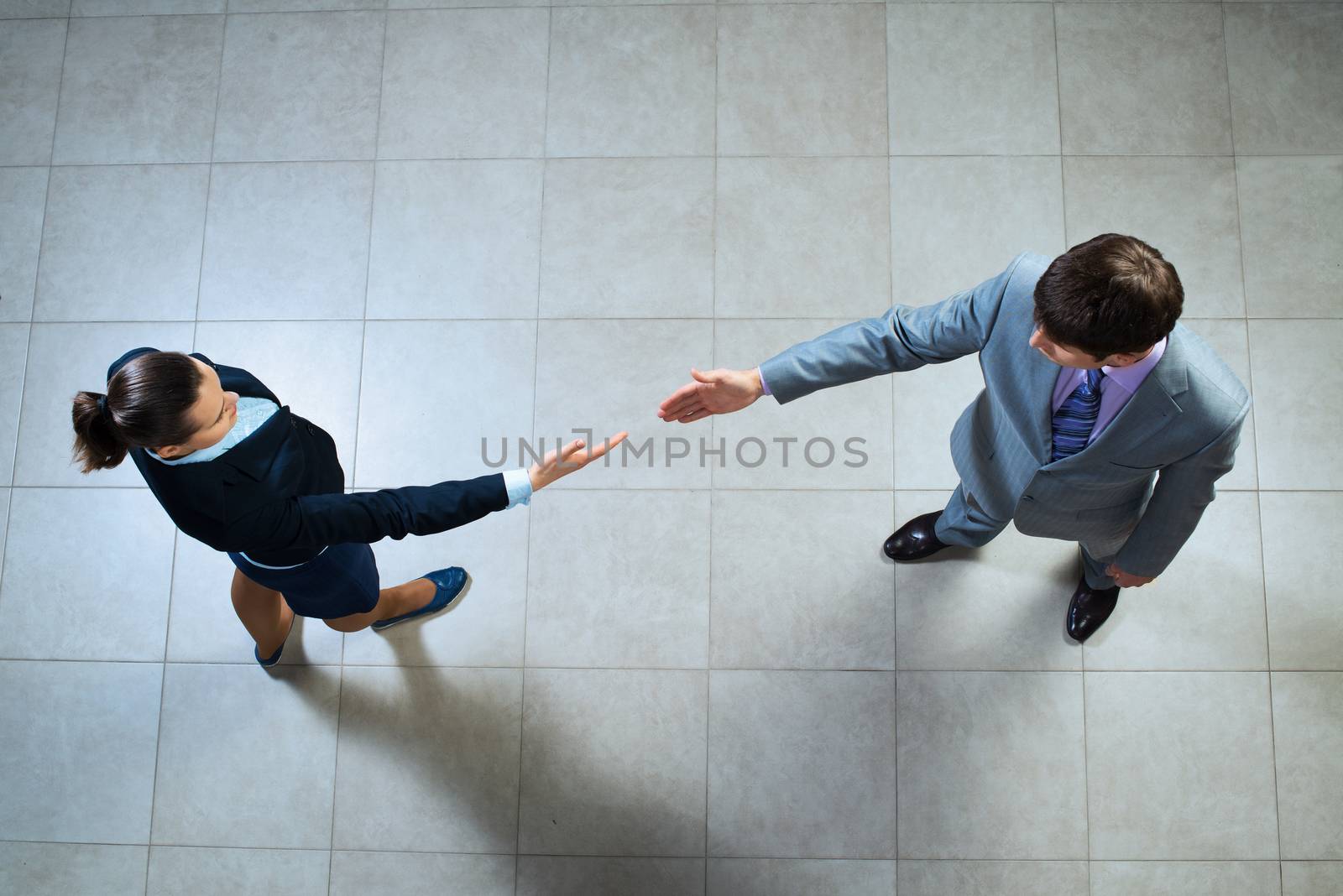 image of a businessmen stretching out their hands towards each other, the future handshake