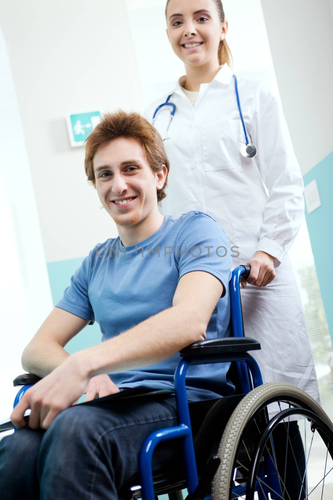 Female nurse pushing her patient on a wheelchair
