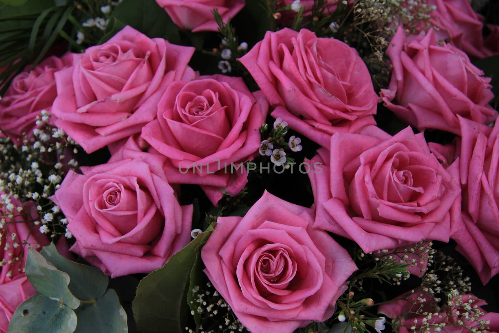 Big pink roses in a wedding bouquet