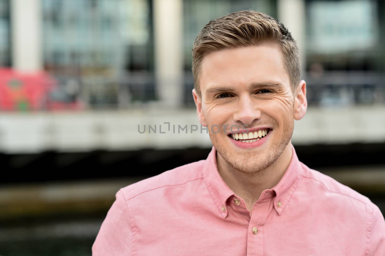 Close of smiling young man at outdoors