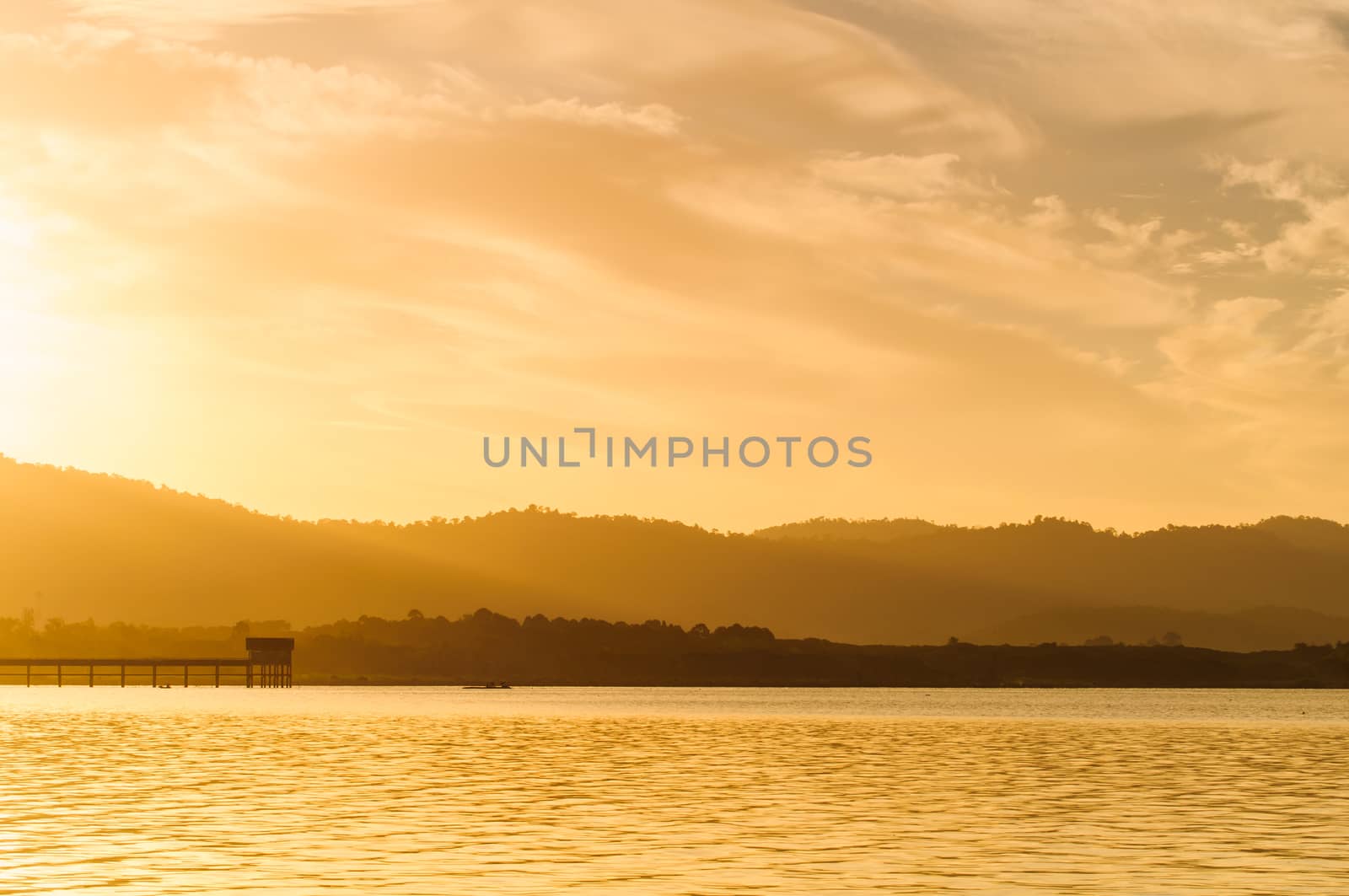 Sunrise on a lake  by Sorapop