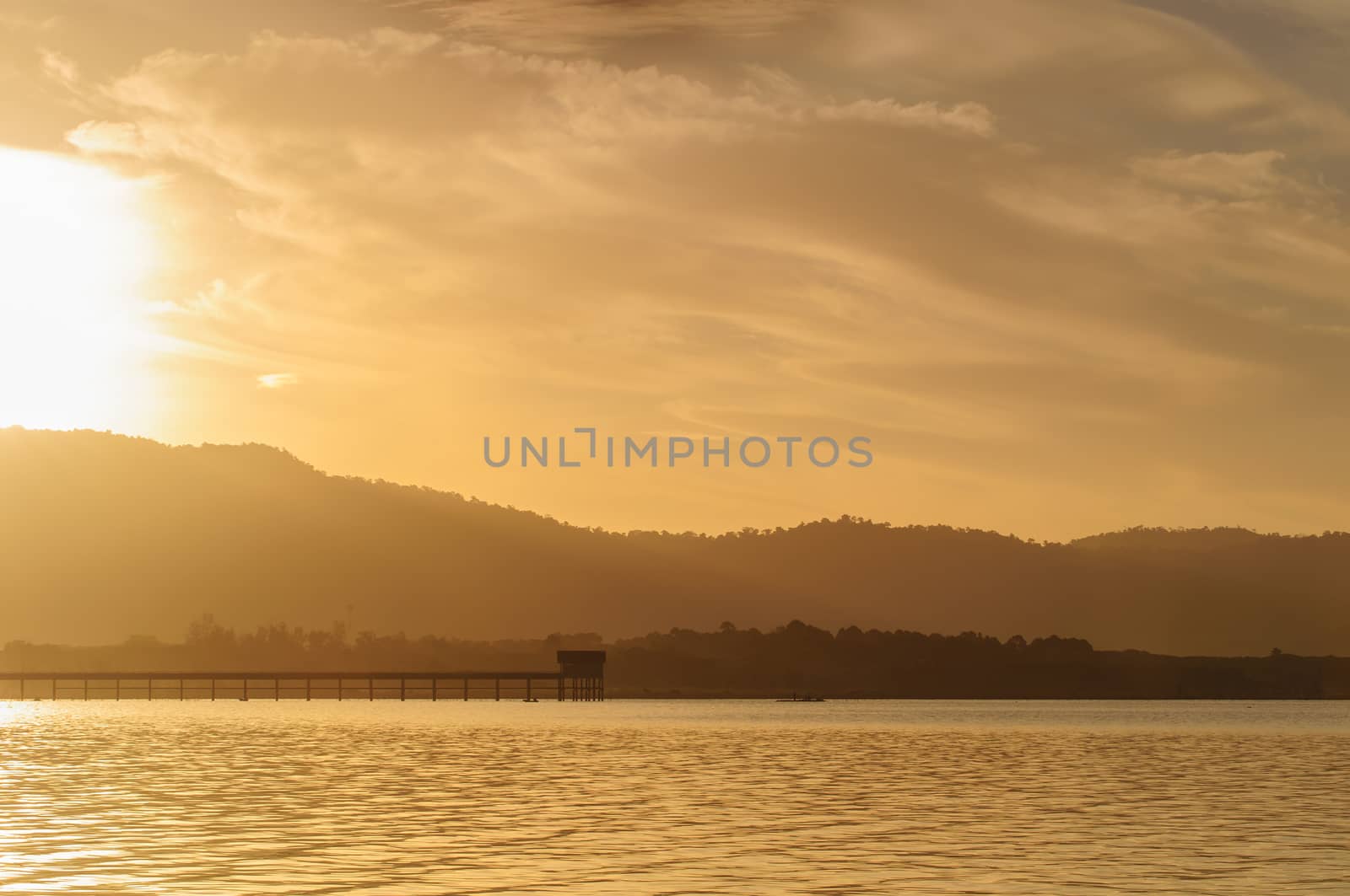Sunrise on a lake  by Sorapop
