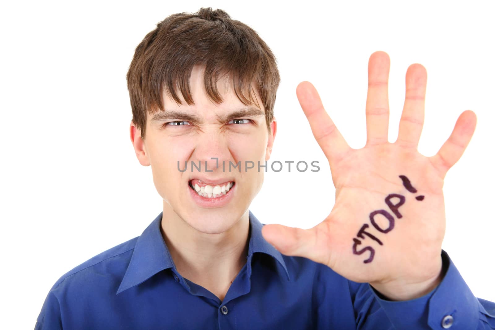 Angry Teenager shows the palm gesture with an inscription Stop Isolated on the White