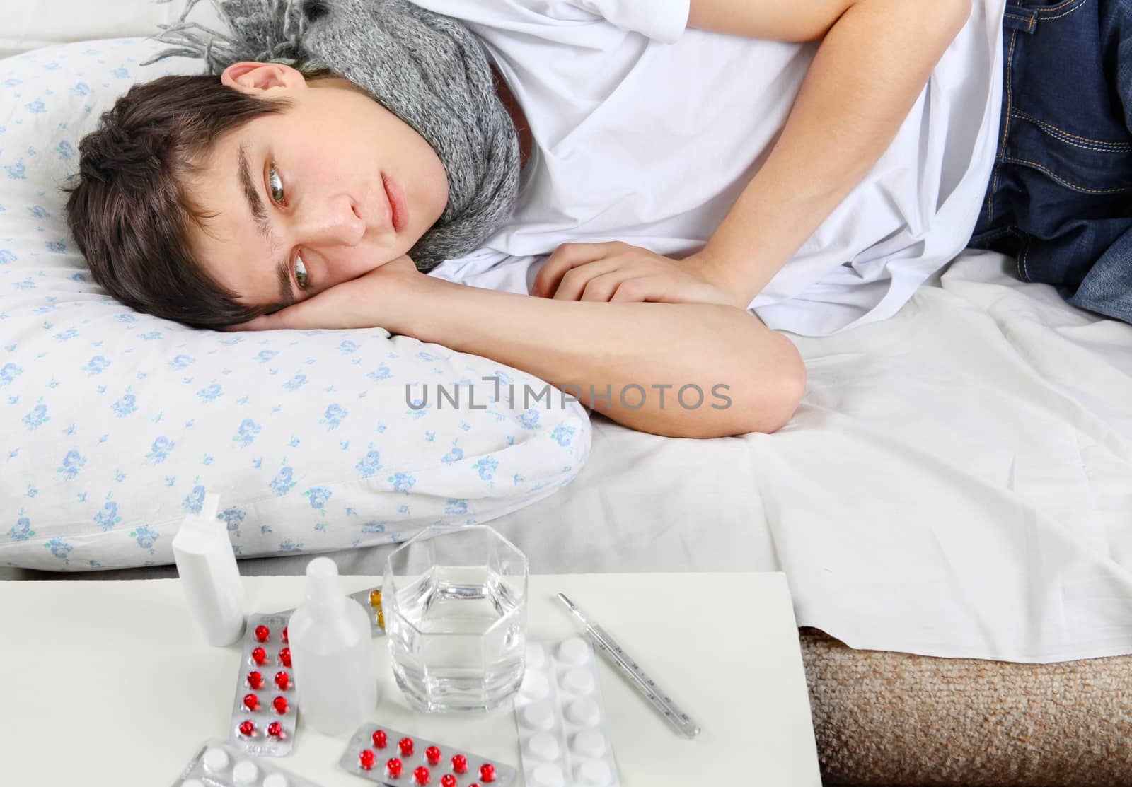 Diseased Young Man lying on the Bed