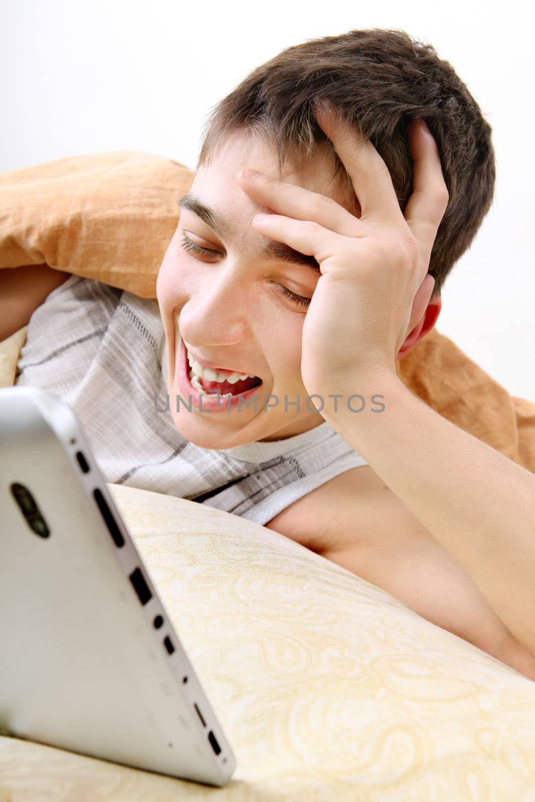 Cheerful Teenager with Tablet Computer at the Home