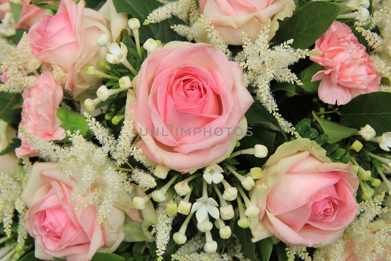 Pink roses and stephanotis in bridal bouquet by studioportosabbia