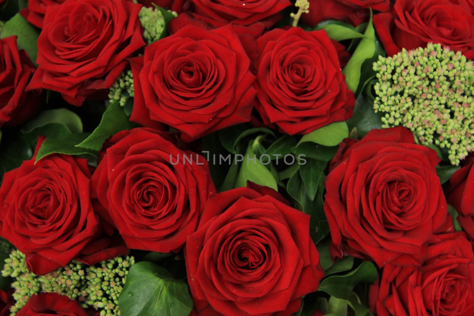 Big red roses in a wedding flower arrangement