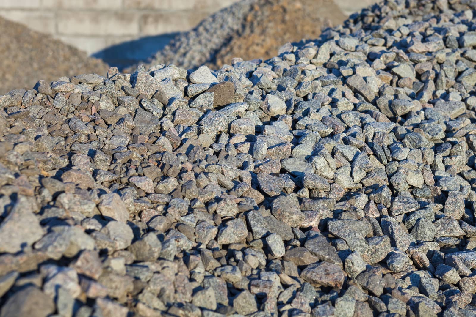 Piles of crushed stones by rootstocks