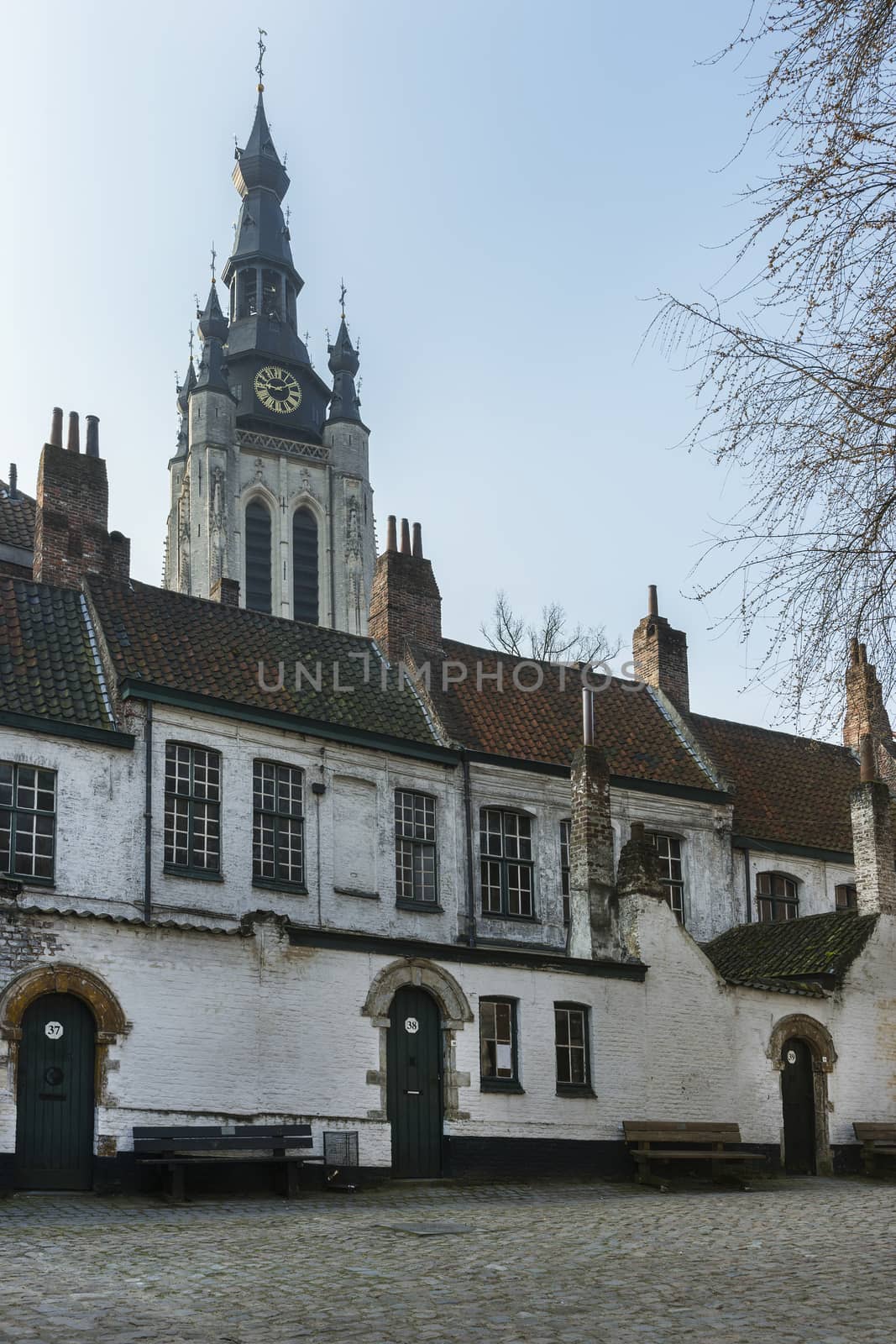 Kortrijk Beguinage and the tower of St. Martin's (Maarten) church. Belgium.