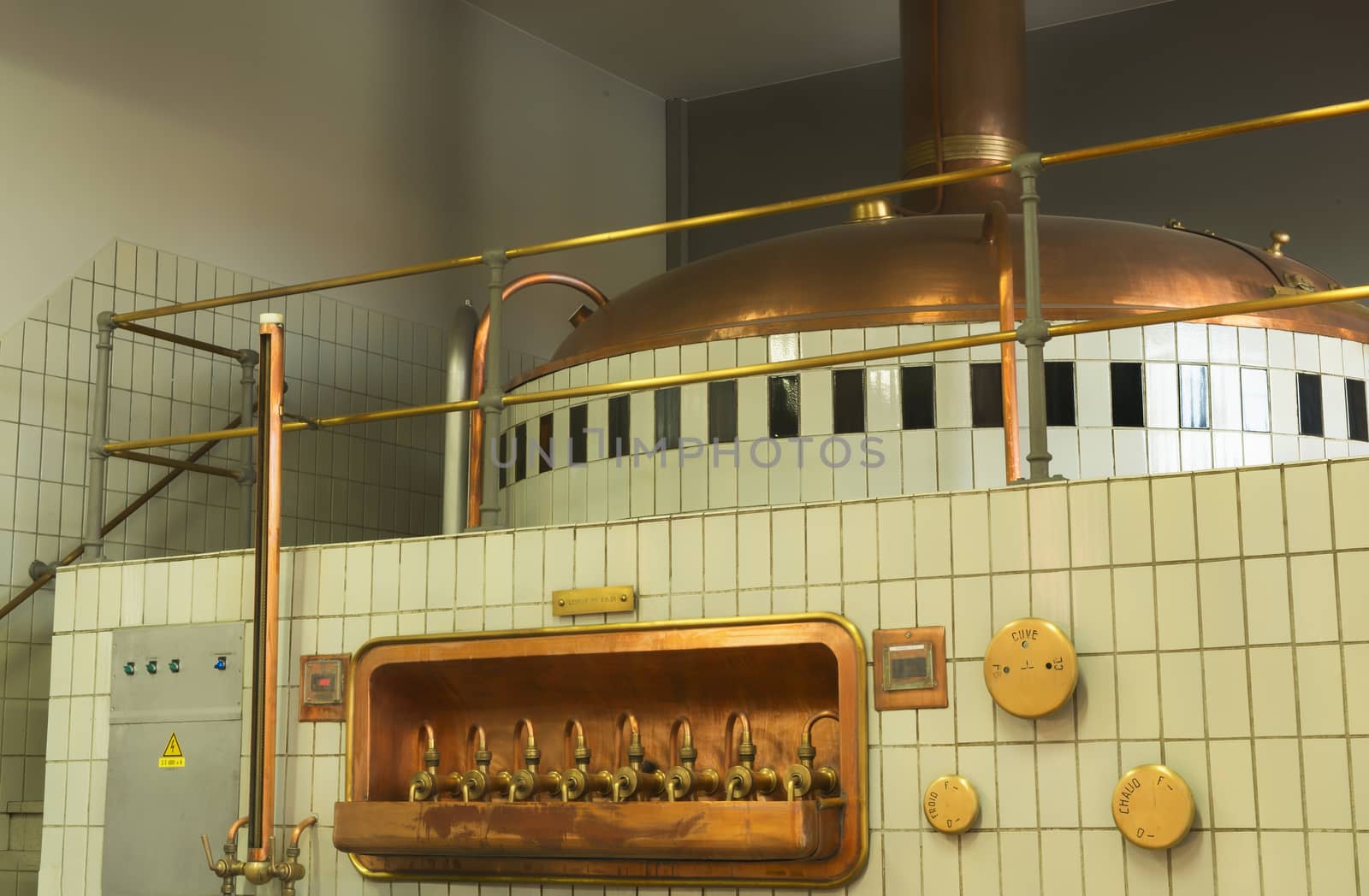 Mash tun and wort siphoning valves in brewery. by Claudine