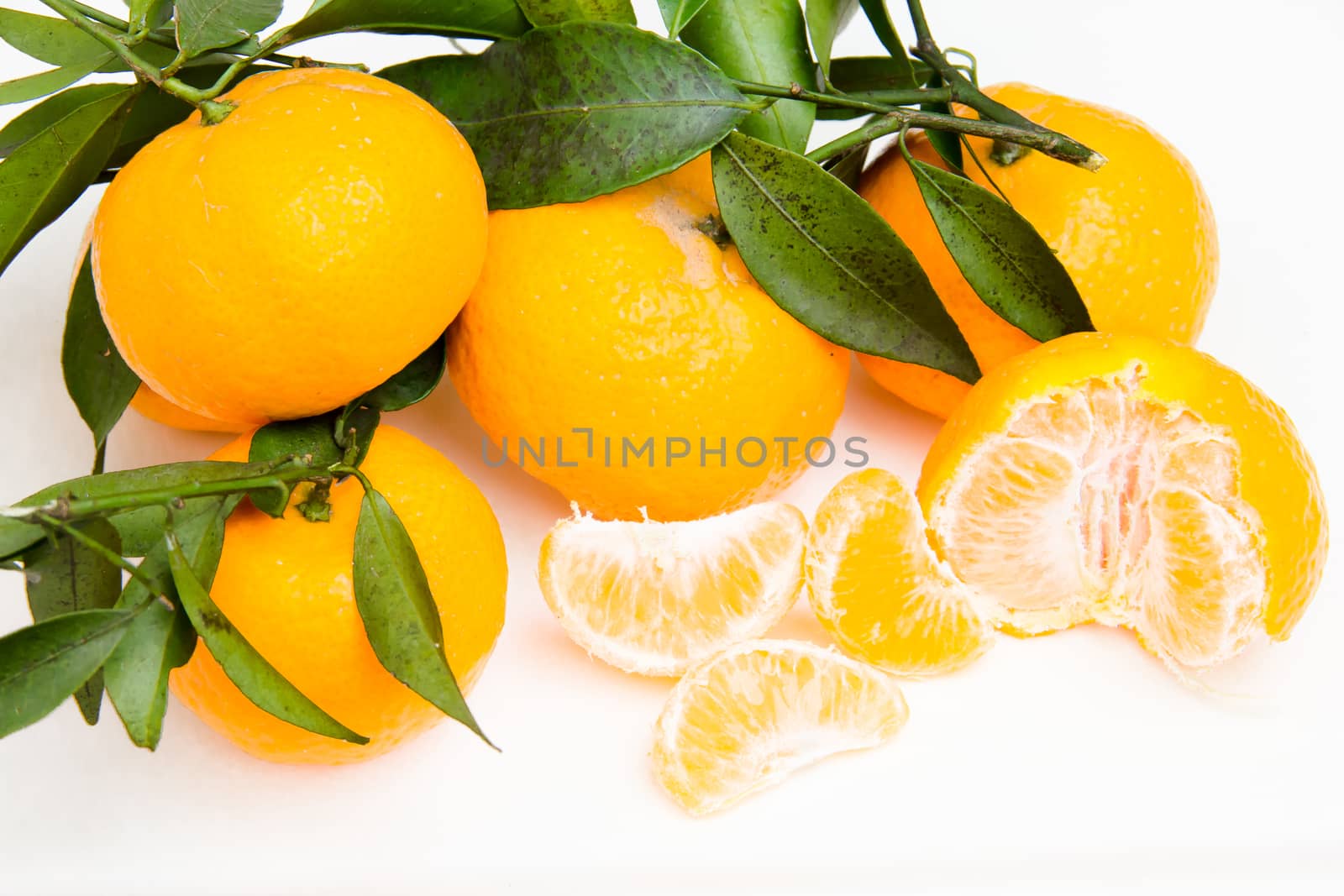 Freshly picked tangerines on a white background