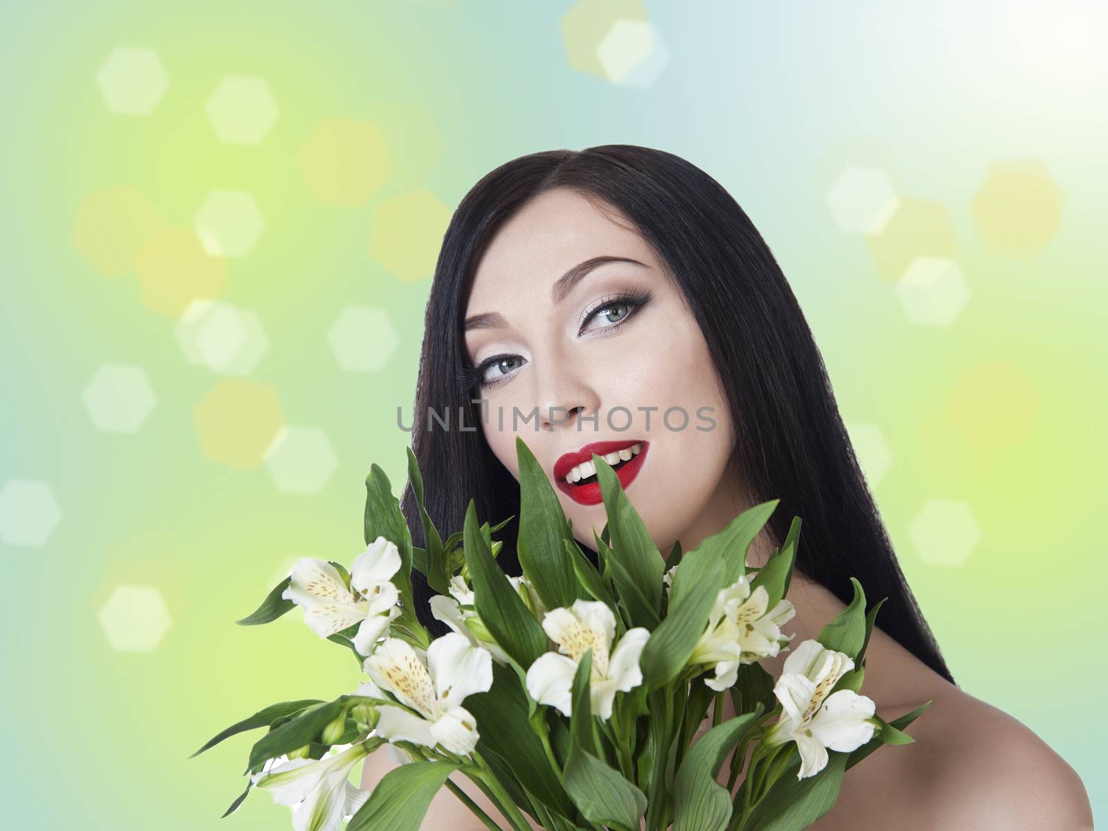 Gentle woman with a bouquet of alstromeria in the background bokeh