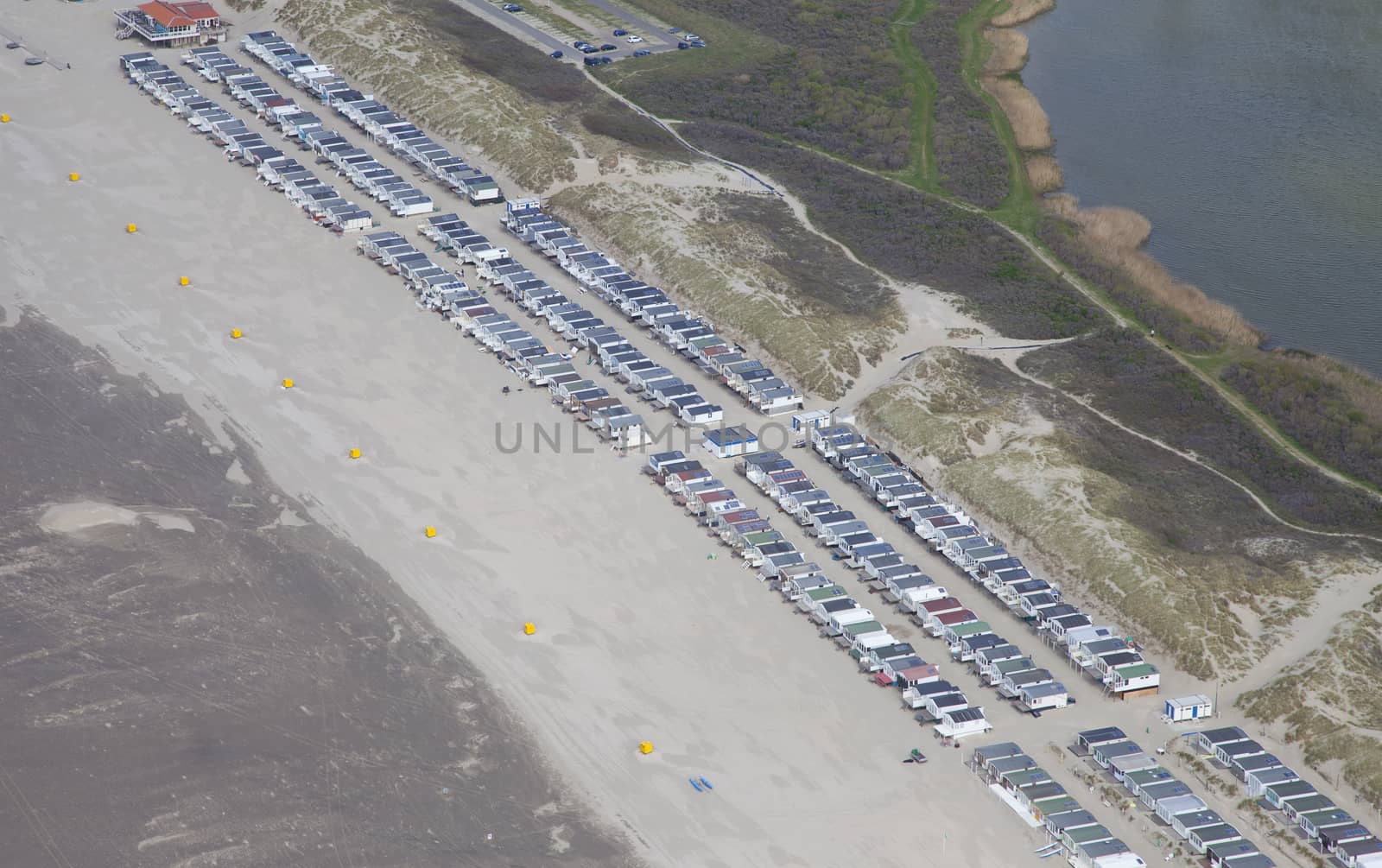 Typical Dutch beachhouses at beach from above, The Netherlands