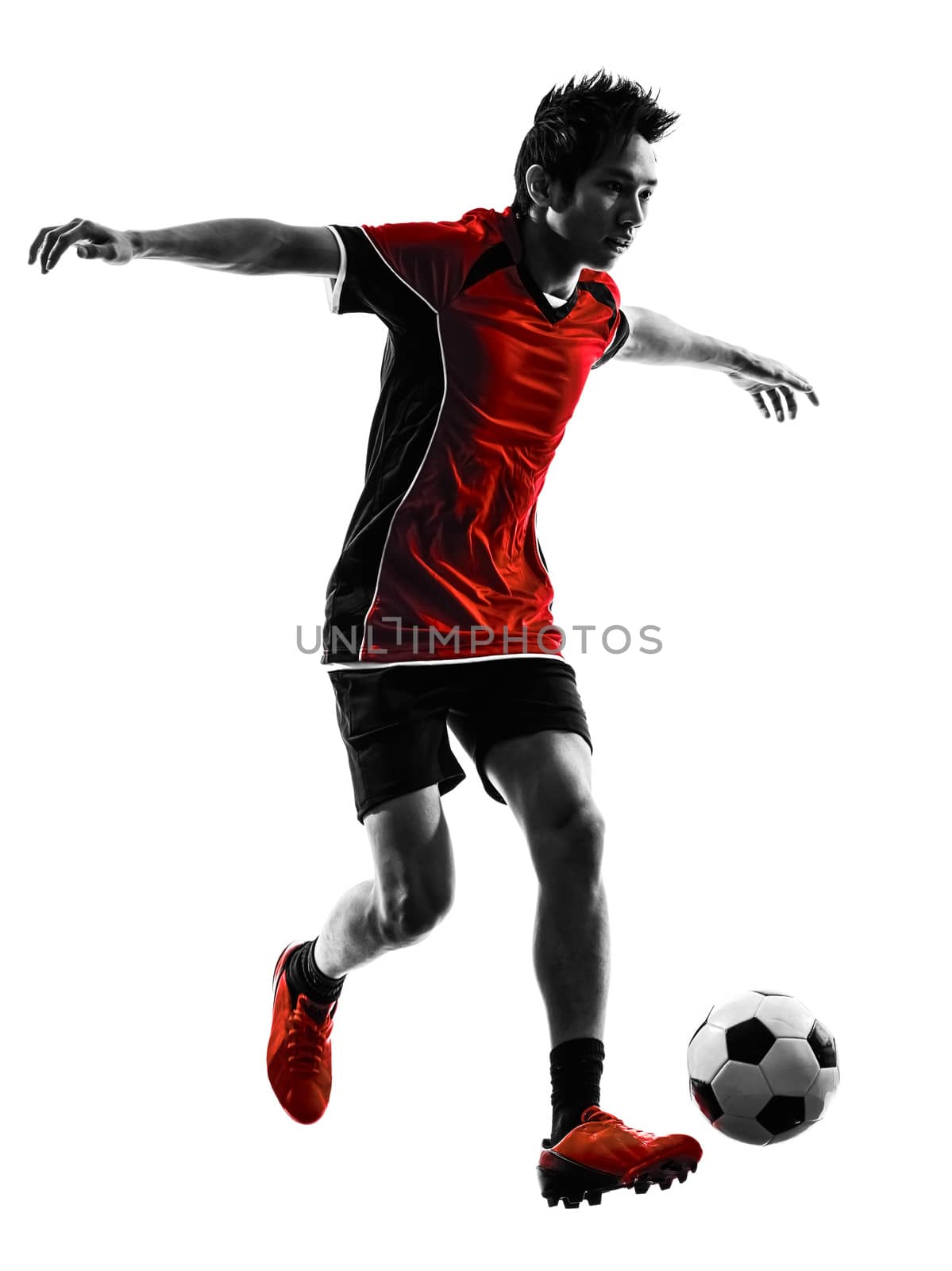 one asian soccer player young man dribbling in silhouette isolated white background