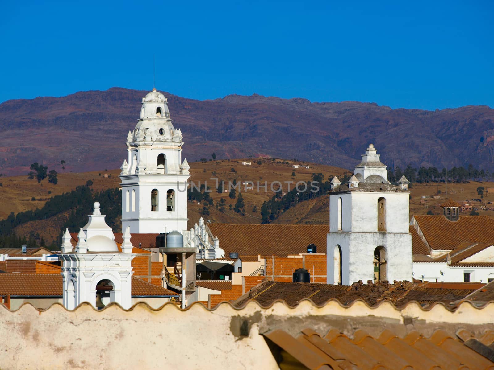 White colonial towers and orange rooftops in Sucre (Bolivia)