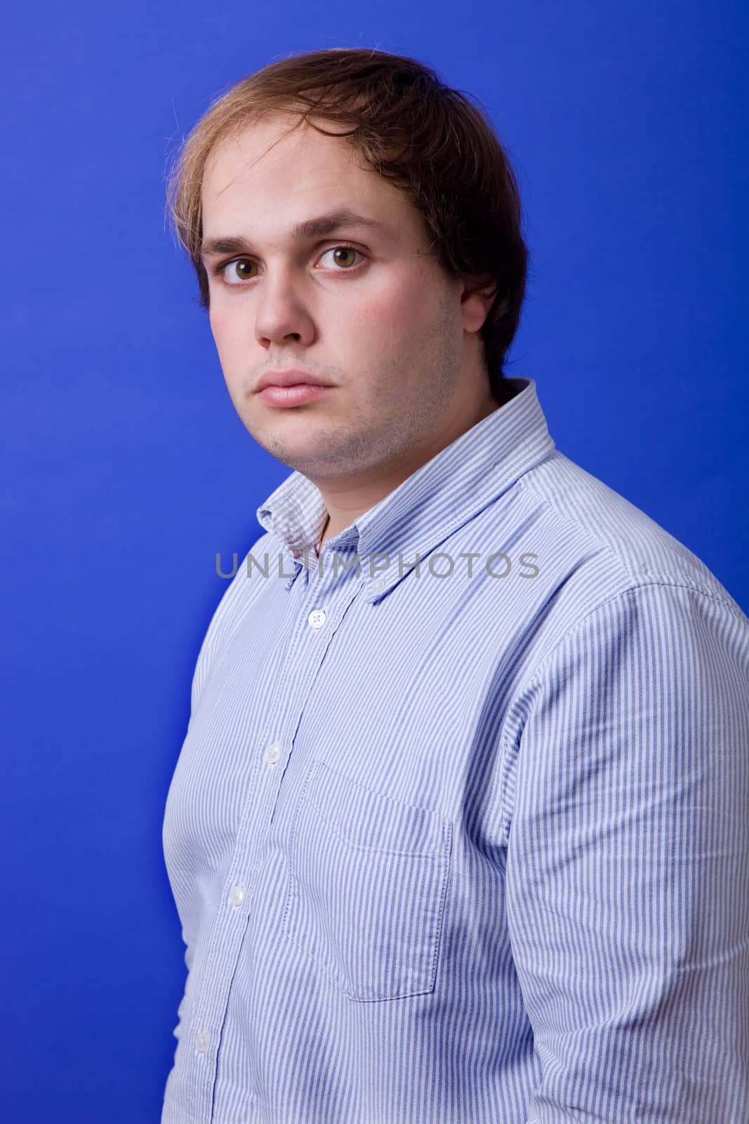 an young man portrait over a blue background