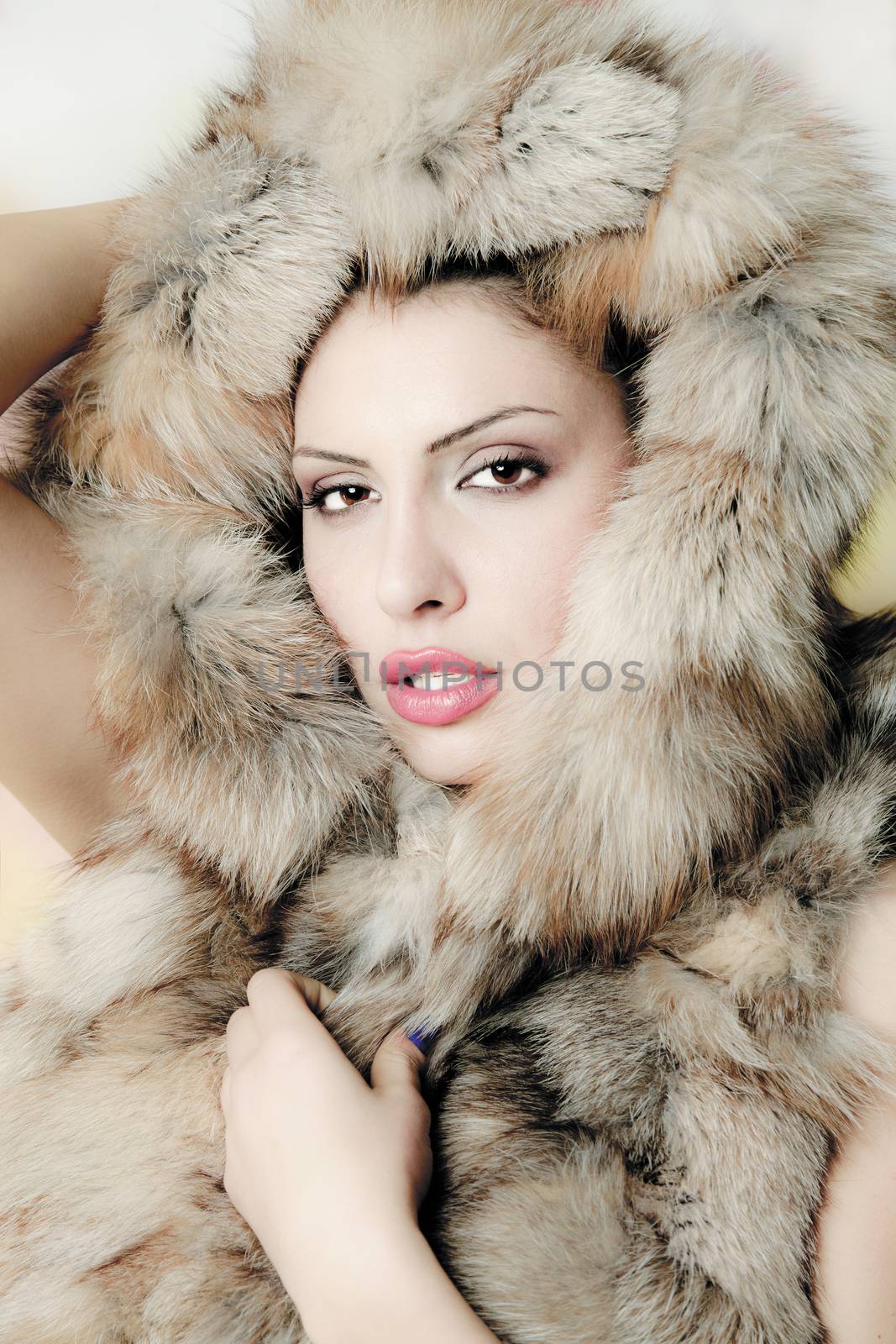 portrait of a beautiful young woman with fur hat isolated on white