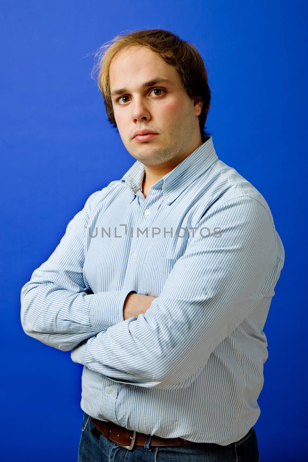 an young man portrait over a blue background