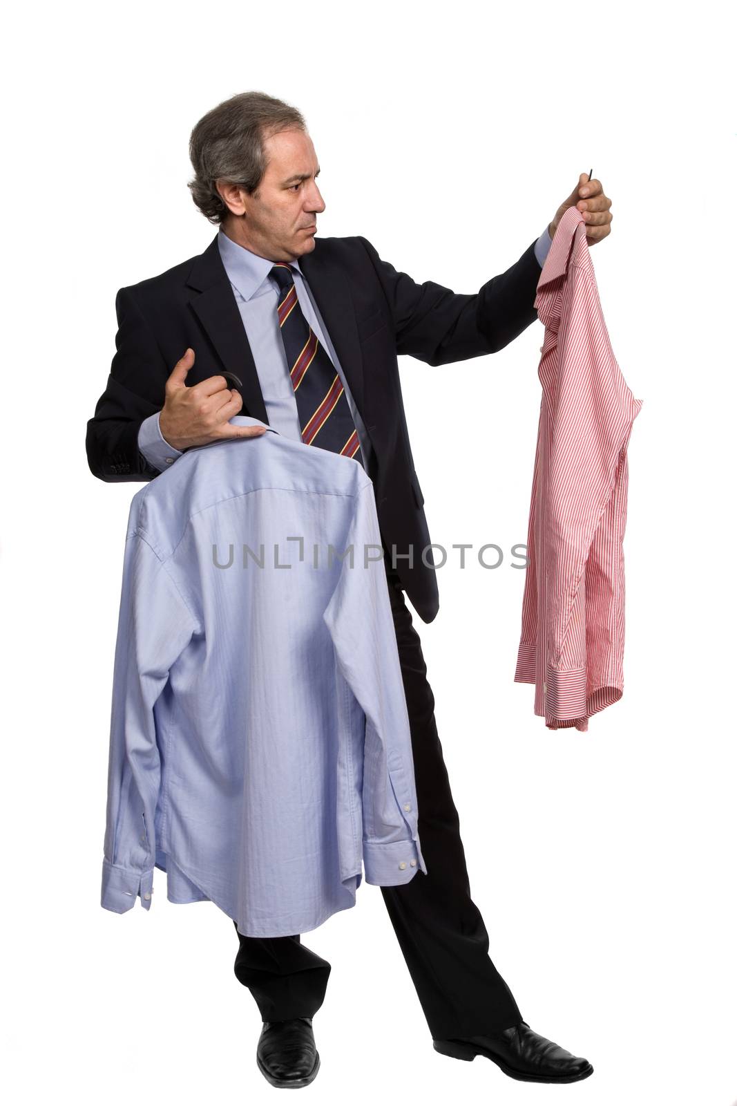mature businessman choosing between two shirts, on white