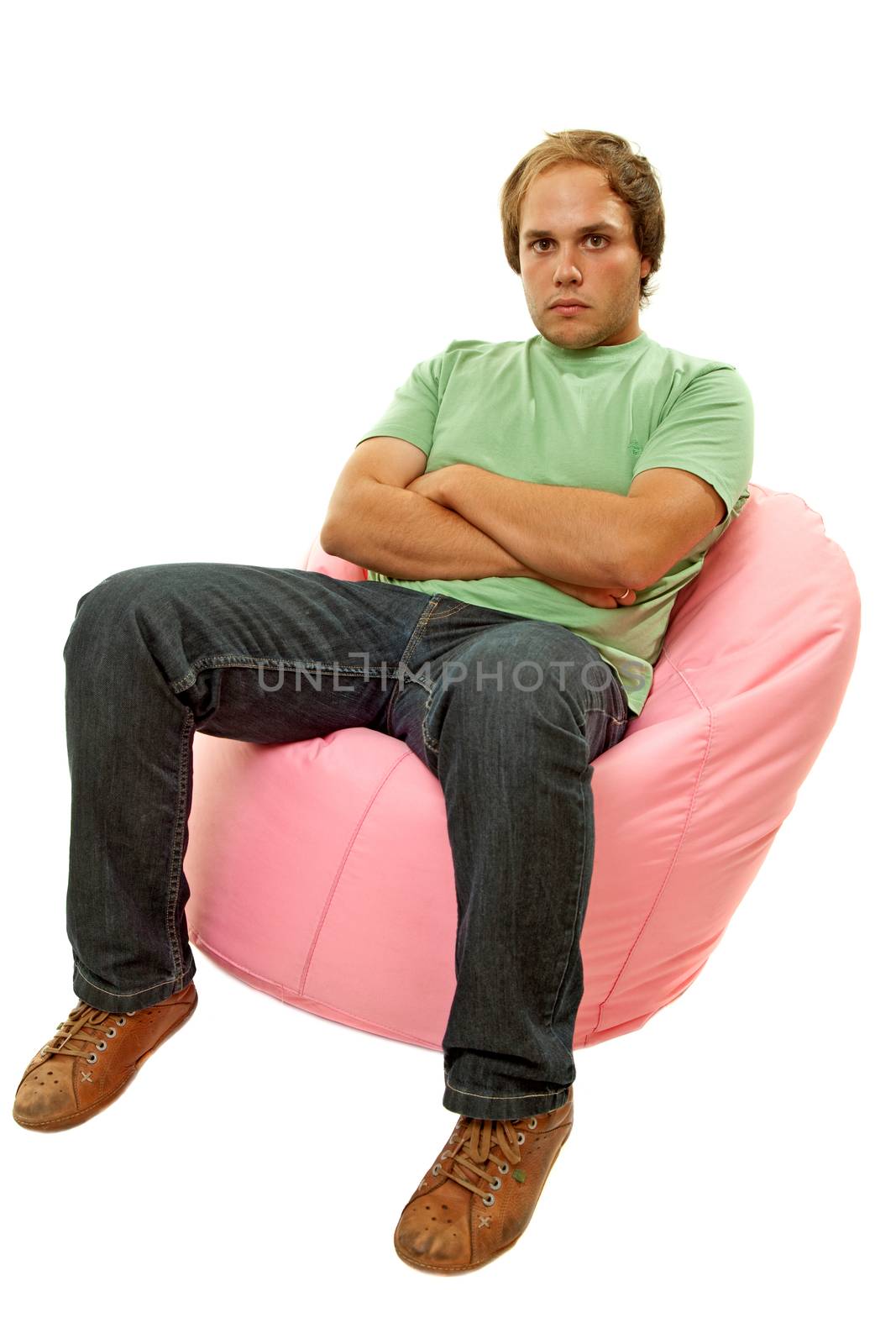 young casual man seated in a small sofa