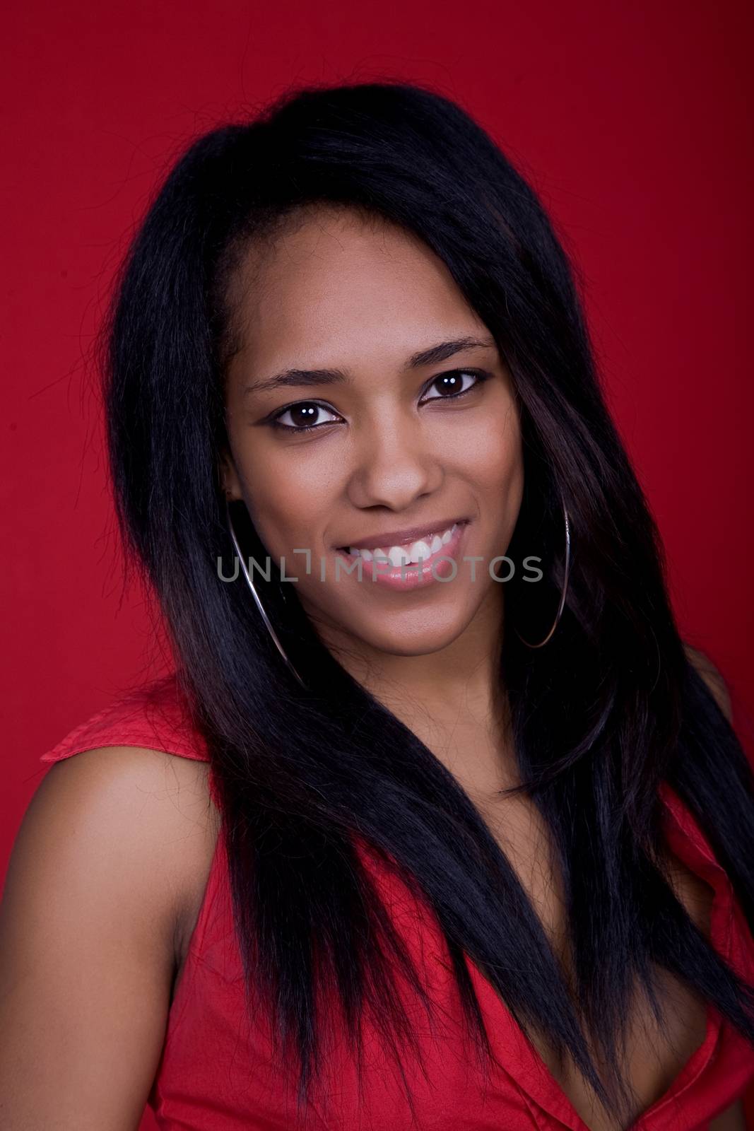 young beautiful woman closeup portrait, on a red background