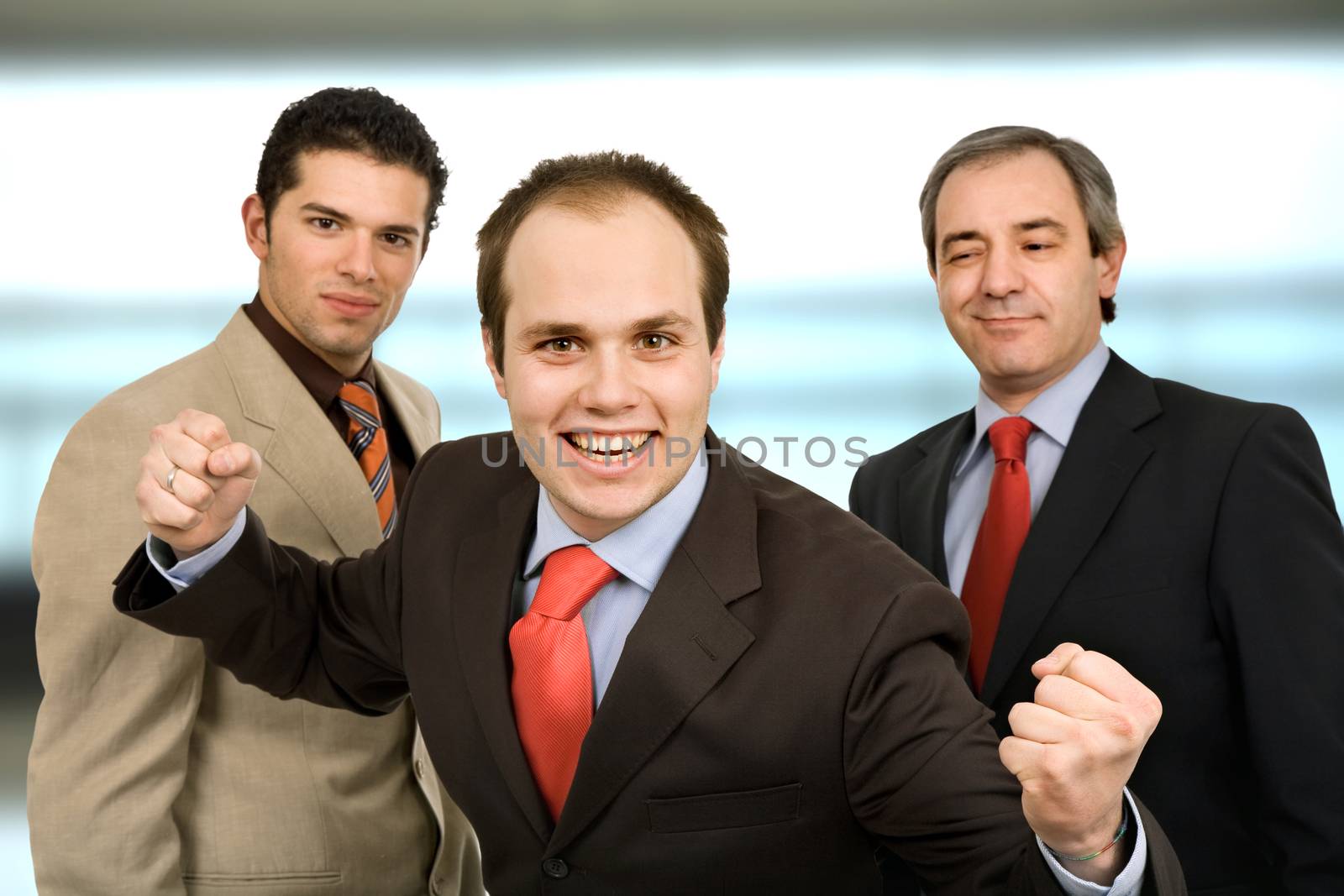 three business men winning at the office