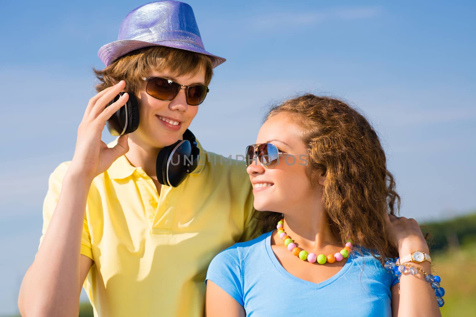 young couple standing on the road, having fun with friends