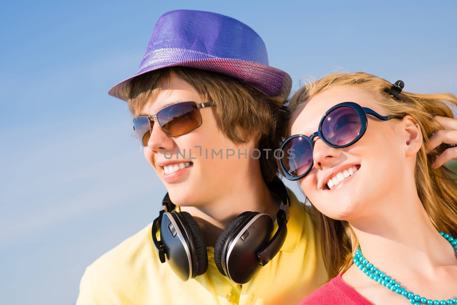 young couple standing on the road, having fun with friends