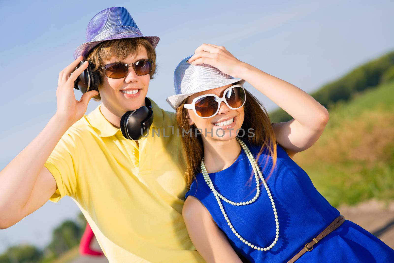 young couple standing on the road, having fun with friends