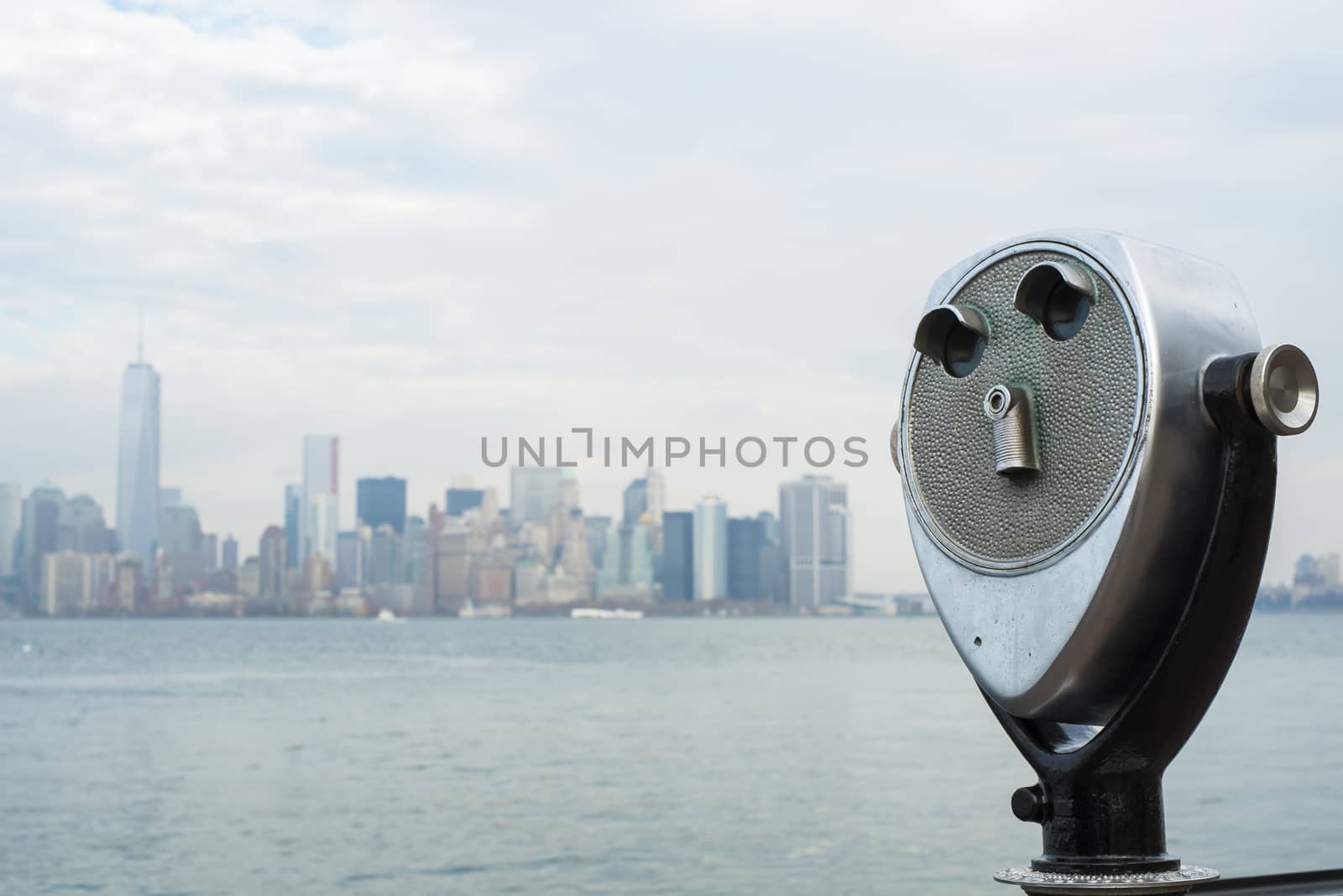 NEW YORK, US - NOVEMBER 22: Binocular viewers with Manhattan skyline in the background across the water. November 22, 2013 in New York.