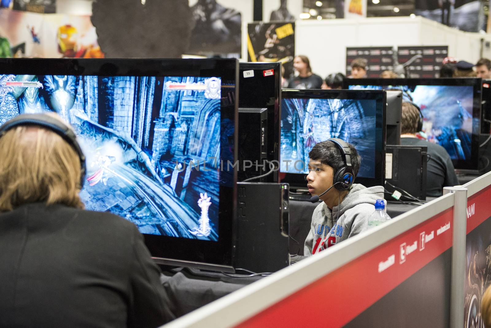 LONDON, UK - OCTOBER 26: Players testing previews of games to be released in 2014, inside the exhibition hall at the Excel Centre's Comicon. October 26, 2013 in London.