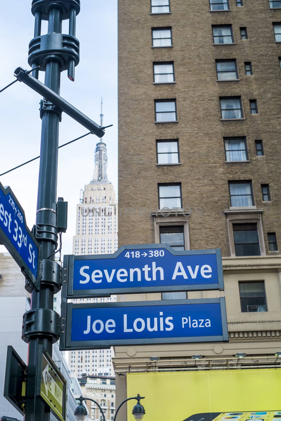 NEW YORK, US - NOVEMBER 23: Seventh Avenue and Joe Louis Plaza street signs. November 23, 2013 in New York.