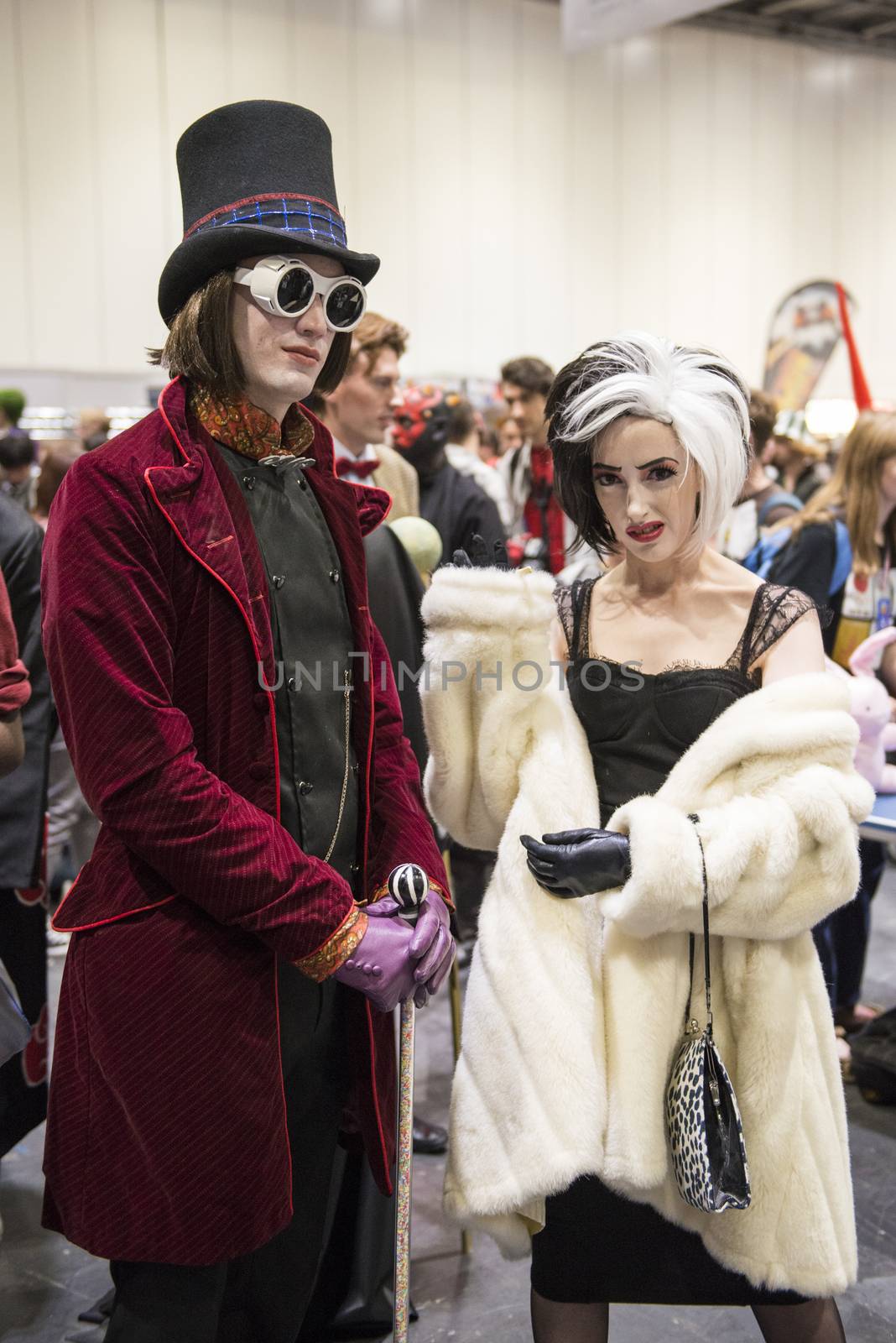 LONDON, UK - OCTOBER 26: Cosplayers dressed as Charlie from the chocolate Factory and Cruella de Vil from 101 Dalmatians for the Comicon at the Excel Centre's MCM Expo. October 26, 2013 in London.