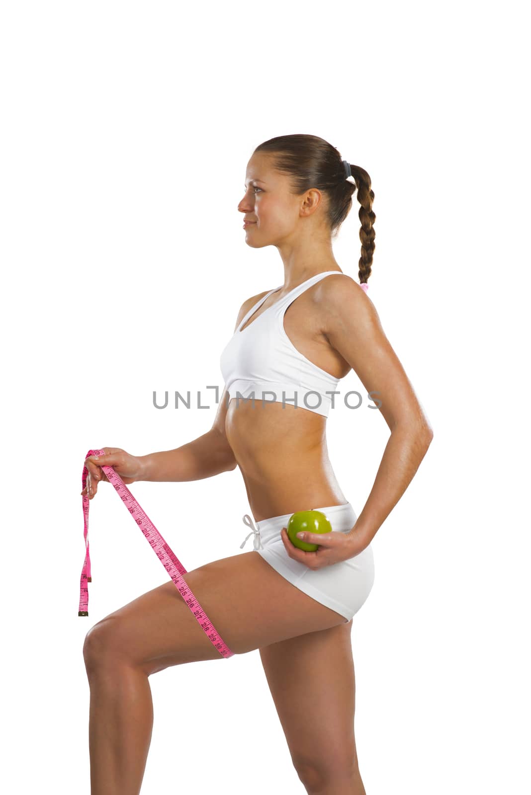 image of a young attractive woman with measuring tape and green apple