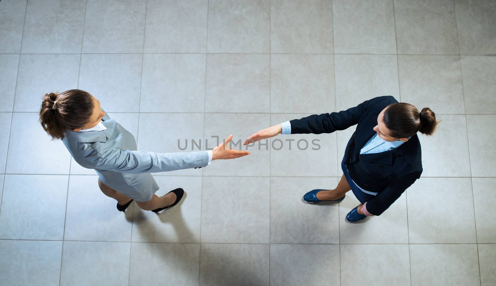 image of a businessmen stretching out their hands towards each other, the future handshake