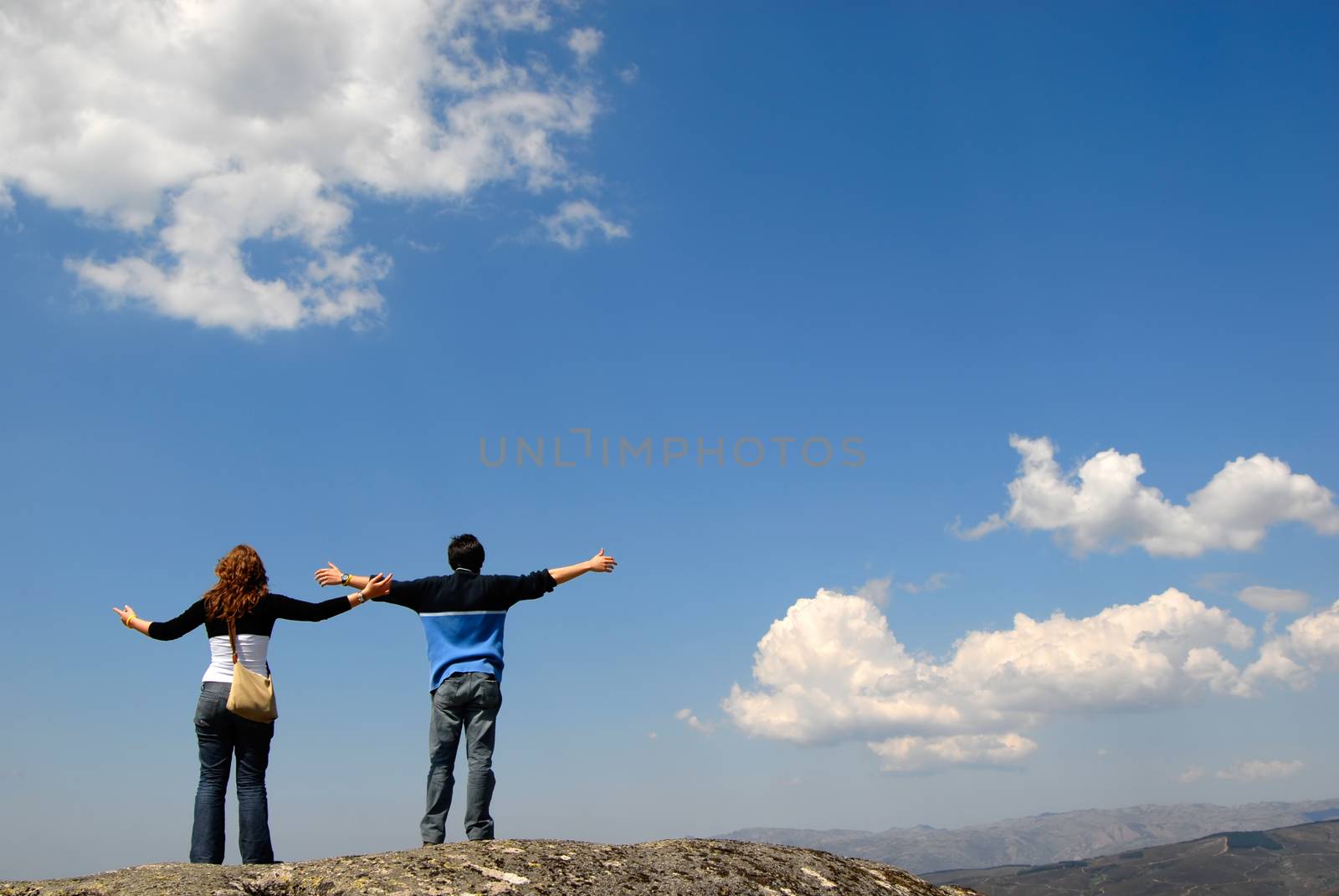 young couple in the top of the mountain