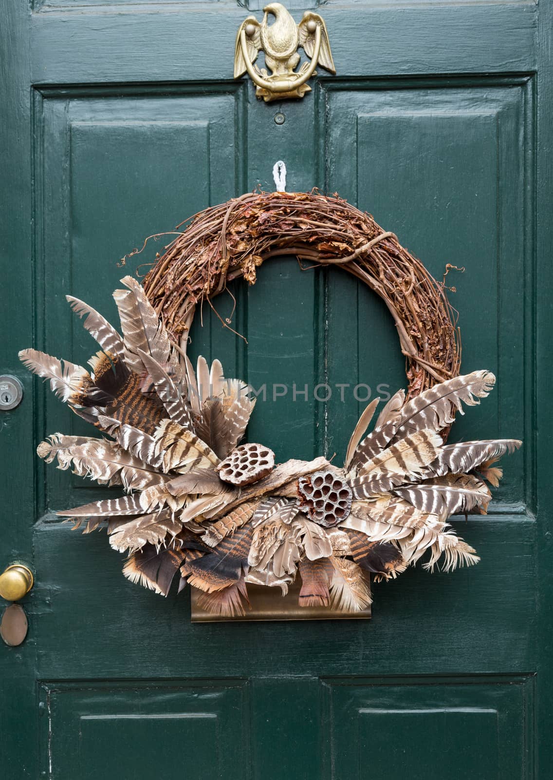 Traditional design of a christmas wreath attached to the front door of old house