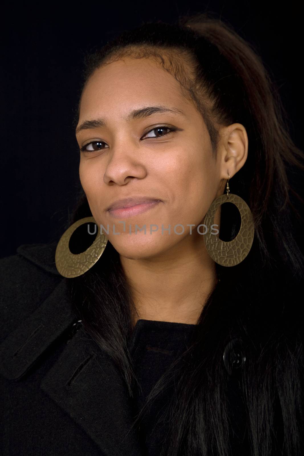 young beautiful woman close up portrait, on black background