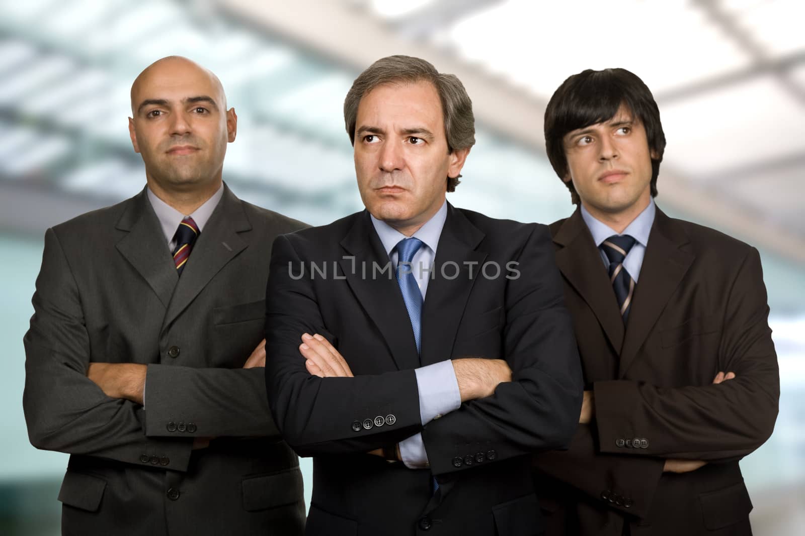 team of three business men standing pensive