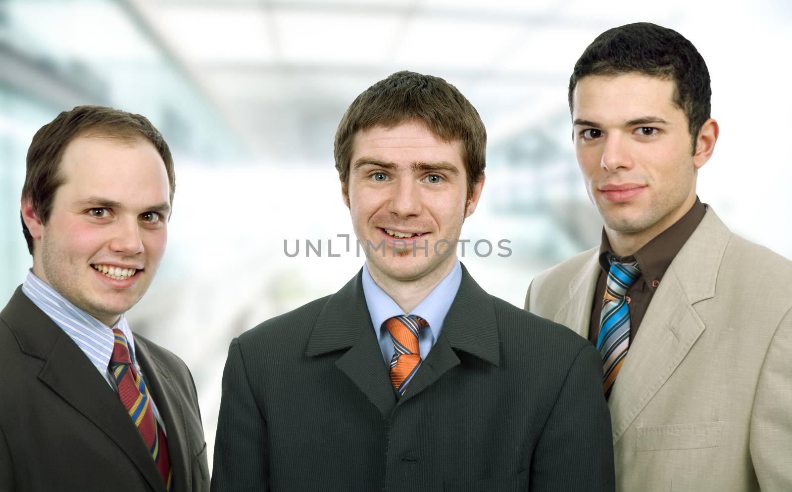 three happy business men together as a team