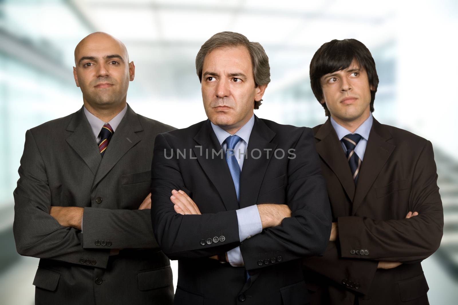 team of three business men standing pensive