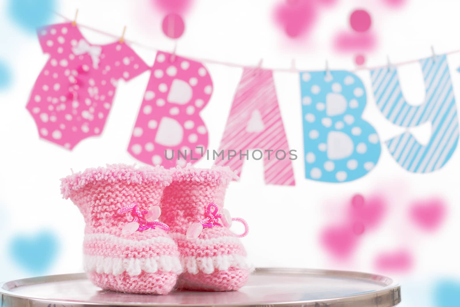 Cute baby element with word baby and pink bootees over white