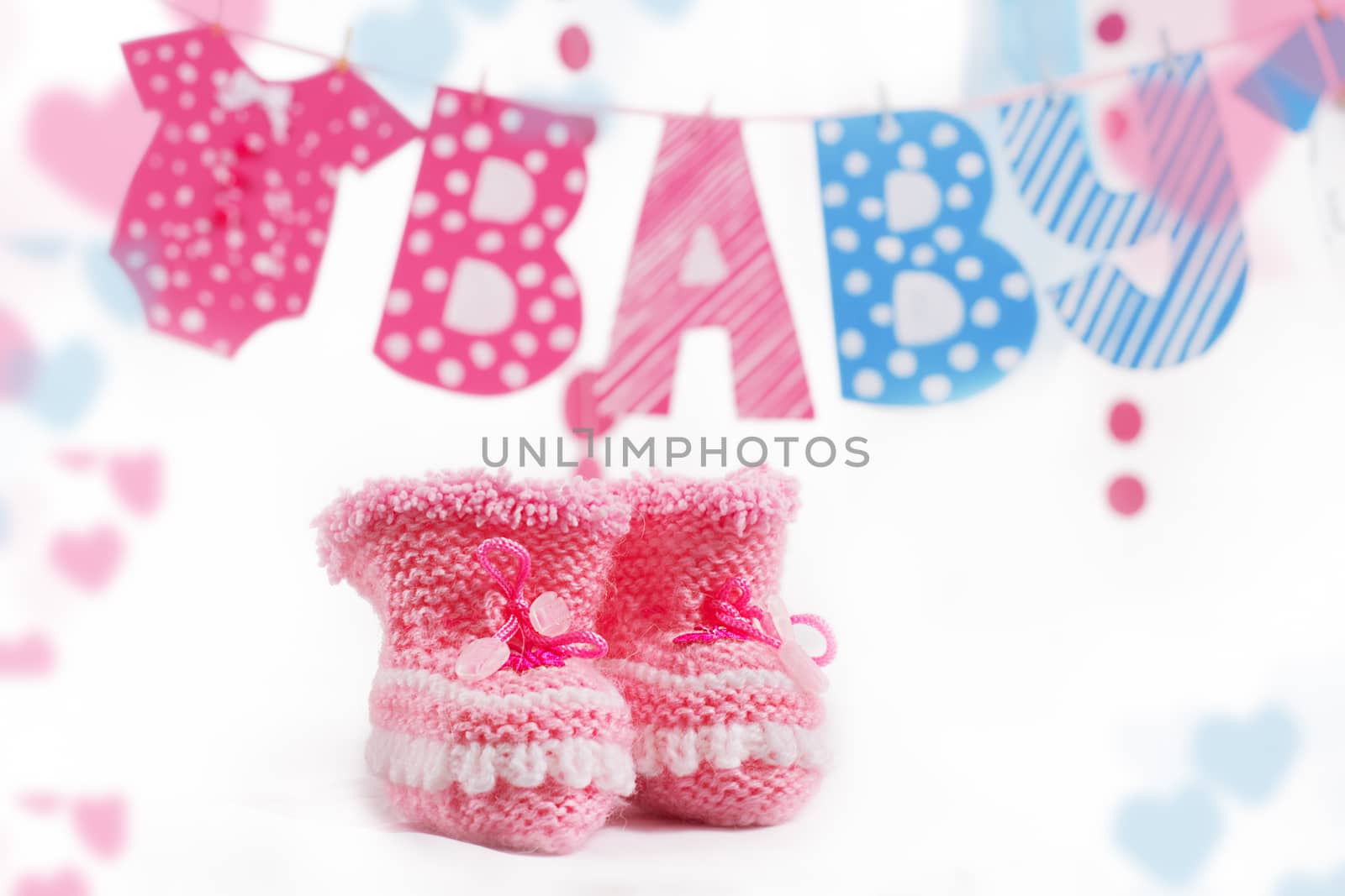Pink bootees and baby word garland as decoration