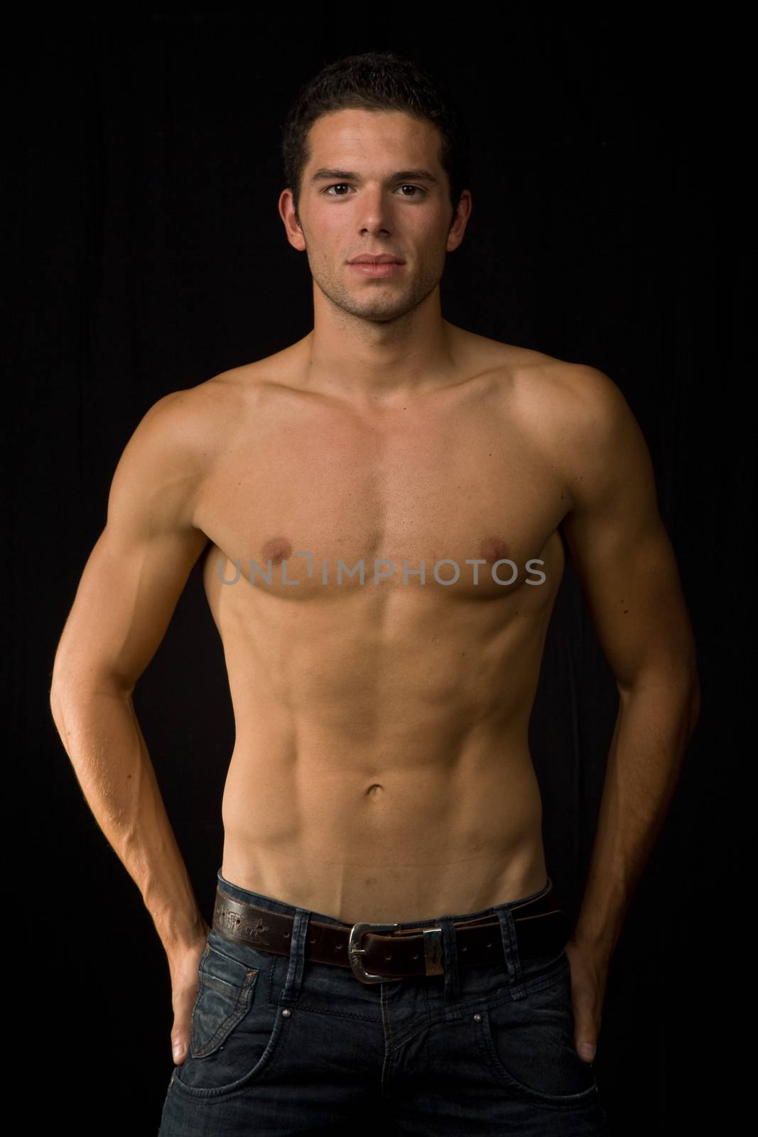 young sensual man on a black background